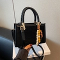 Black faux suede small crossbody bag with woven handles and vintage beaded charm accent - Black with Pendant