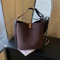 Dark brown faux suede bucket bag with gold clasp and adjustable shoulder strap - Brown