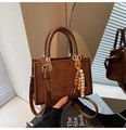 Retro brown suede crossbody bag with woven handles and ethnic beaded charm detail - Brown with Pendant