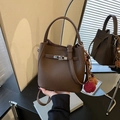 Brown lychee leather bucket bag with silver turn-lock and colorful pompom charm - Coffee with Pendant
