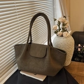 Olive green faux suede large tote bag with shoulder strap in cozy interior lighting - Green
