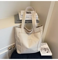 Detail of cream canvas tote bag featuring white Midolai embroidery and a front pocket - Off White