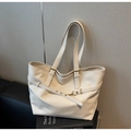 Detail view of cream leather tote bag with gold buckle hardware and fine texture - Off-white