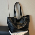 Minimalist black faux leather tote bag with gold hardware and adjustable strap - Black