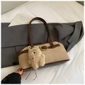 Close-up of retro brown and beige patchwork shoulder bag with plush bear charm detail - With Charm / Khaki