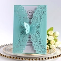 Elegant laser cut blue wedding invitation with butterfly detail on a white decorative plate - Tiffany Blue