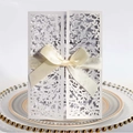 Laser cut white floral wedding invitation with beige silk ribbon on elegant plate - White
