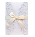 Detail of laser-cut leaf pattern on white invitation card with a silk ribbon bow - White