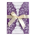 Detail of laser-cut purple wedding invitation with white ribbon and ornate leaf patterns - Dark Purple