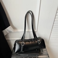 Detail of black cylindrical shoulder bag with matte leather and silver buckle accents - Black