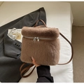 Detail of plush brown backpack with soft faux fur texture and leather handle - Coffee