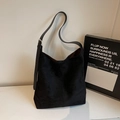 Detail of black suede hobo tote bag featuring adjustable strap and silver metal buckle - Black