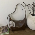 Close-up of brown hobo bag in vintage oil wax leather with cute plush bunny keychain - Brown with Pendant