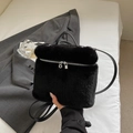 Furry black plush handbag with crossbody leather strap in a cozy autumn setting - Black