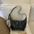 Black crescent shoulder bag in glossy crinkled faux leather with plush elephant charm - Black with Pendant