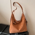 Brown suede hobo bag featuring heart pendant and wooden bead tassel details - With Charm / Brown