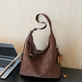 Vintage dark brown large tote bag with floral pendant and tassel in office setting - With Charm / Brown