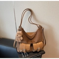 Detailed close-up of brown suede tote bag with double pockets and plush bear charm - With Charm / Brown