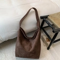 Primer plano del bolso hobo de ante marrón con gran capacidad y hebilla de metal dorado - Marrón