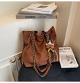 Detail of brown suede tote bag featuring silver chain strap and cute teddy bear charm - Brown with Pendant