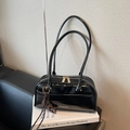 Chic black patent leather pillow bag with long straps and gold zipper details - Black with Pendant