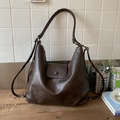 Detail view of deep brown hobo bag with textured leather surface and stylish buckle closure - Coffee without Pendant