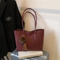 Burgundy leopard print tote bag with brown fur ball charm on white background - Red with Pendant