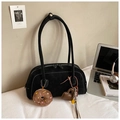 Detail of black suede underarm bag with contrast stitching and plush donut charm - Black With Pendant