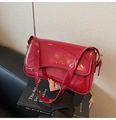 Detail of red glossy patent leather shoulder bag with golden metallic buckle adjustment - Red