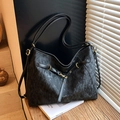 Minimalist black tote bag with vintage texture and gold hardware details - Black