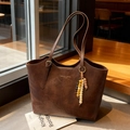Brown vintage leather tote bag with elegant beaded charm and gold foil lettering - Coffee with Pendant