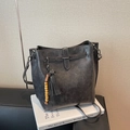 Black bucket bag with tassel and wood bead charm, minimalist PU leather crossbody style - Black