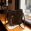 Retro dark coffee bucket bag in premium PU leather featuring wooden bead and tassel charms - Brown