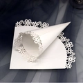 White laser-cut floral wedding petal cones with intricate daisy lace hollow patterns - White