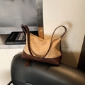 Chic pleated crossbody bag in beige fabric with dark brown leather straps on a black chair - No Pendant / Khaki