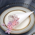 White laser-cut heart pattern paper wedding cone filled with pink and purple petals - White