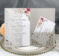 Laser-cut wedding invitation with floral insert and RSVP card on elegant ceramic tray - Silver