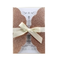 Detail of rose gold glitter laser-cut invitation with cross card and ribbon bow - Apple Gold