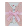 Detail of pink laser-cut wedding invitation with rose pattern and satin ribbon bow - Pink