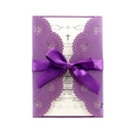 Detail of laser-cut purple floral invitation with elegant satin ribbon and white insert - Deep purple
