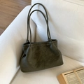 Vintage olive green matte tote bag with white contrast stitching on a sofa - Green Without Pendant