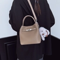 Brown bucket bag in pebbled leather with twist lock and cute bunny pendant charm - With Charm / Elephant Gray