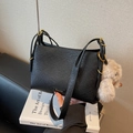 Black pebbled leather shoulder bag with gold hardware and a cute plush bunny charm - Black with Pendant