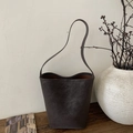 Minimalist charcoal grey bucket bag with a matte texture and sleek shoulder strap - Ebony without Pendant
