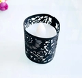 Detailed view of white LED tea light with black laser-cut hollow pattern sleeve - Black Khaki
