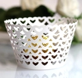 Close-up of white laser-cut cupcake wrappers with heart pattern for party decor - 5cm / White