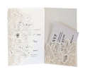 Macro shot of laser-cut floral lace patterns on ivory wedding invitation card set - Ivory