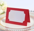 Pink laser-cut lace wedding place card on an elegant white dinner plate with flowers - Pearlescent Red