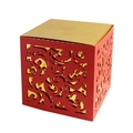 Close-up of laser-cut red and gold wedding candy box with intricate scroll patterns - Red + Gold