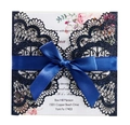 Macro detail of navy blue laser-cut lace invitation with glitter and satin ribbon - Glitter Dark Blue